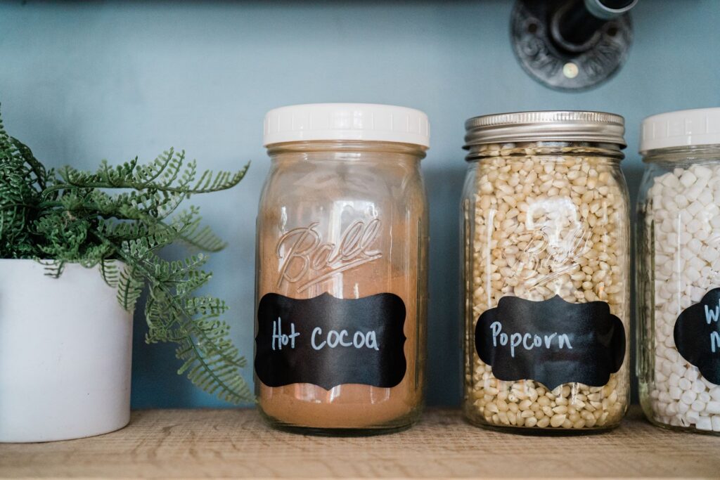 organized pantry with labeled glass jars