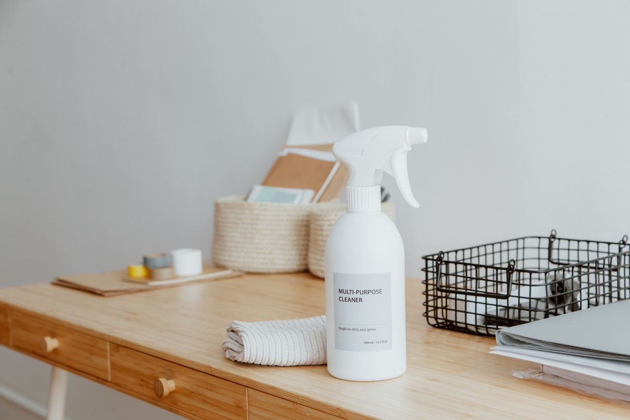 Multi-purpose cleaner on a desk for a weekly cleaning schedule